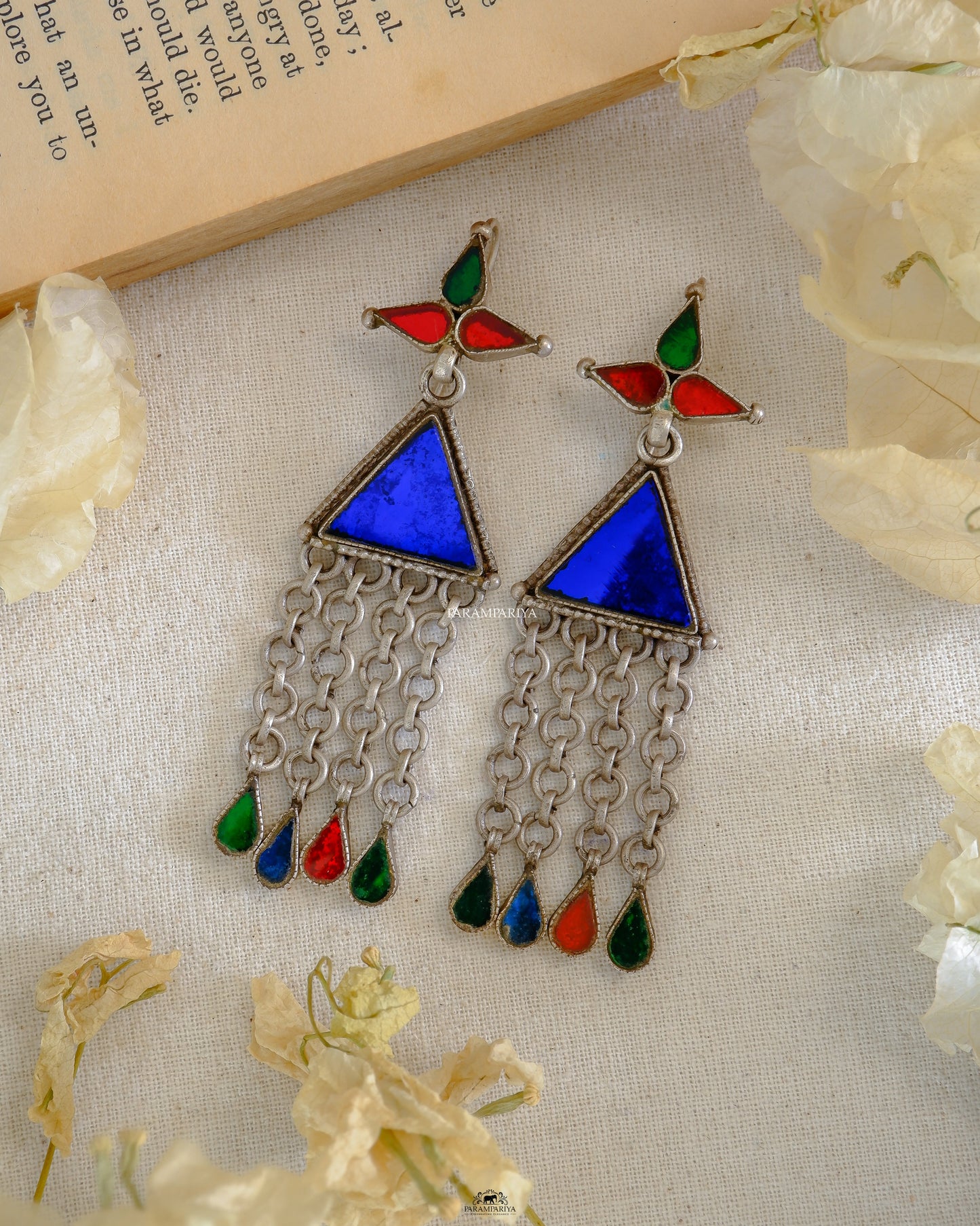 Enchant those around you with these stunning Neptune Earrings. Crafted from pure silver and adorned with a tribal finish glass, these earrings will be sure to make a lasting impression.