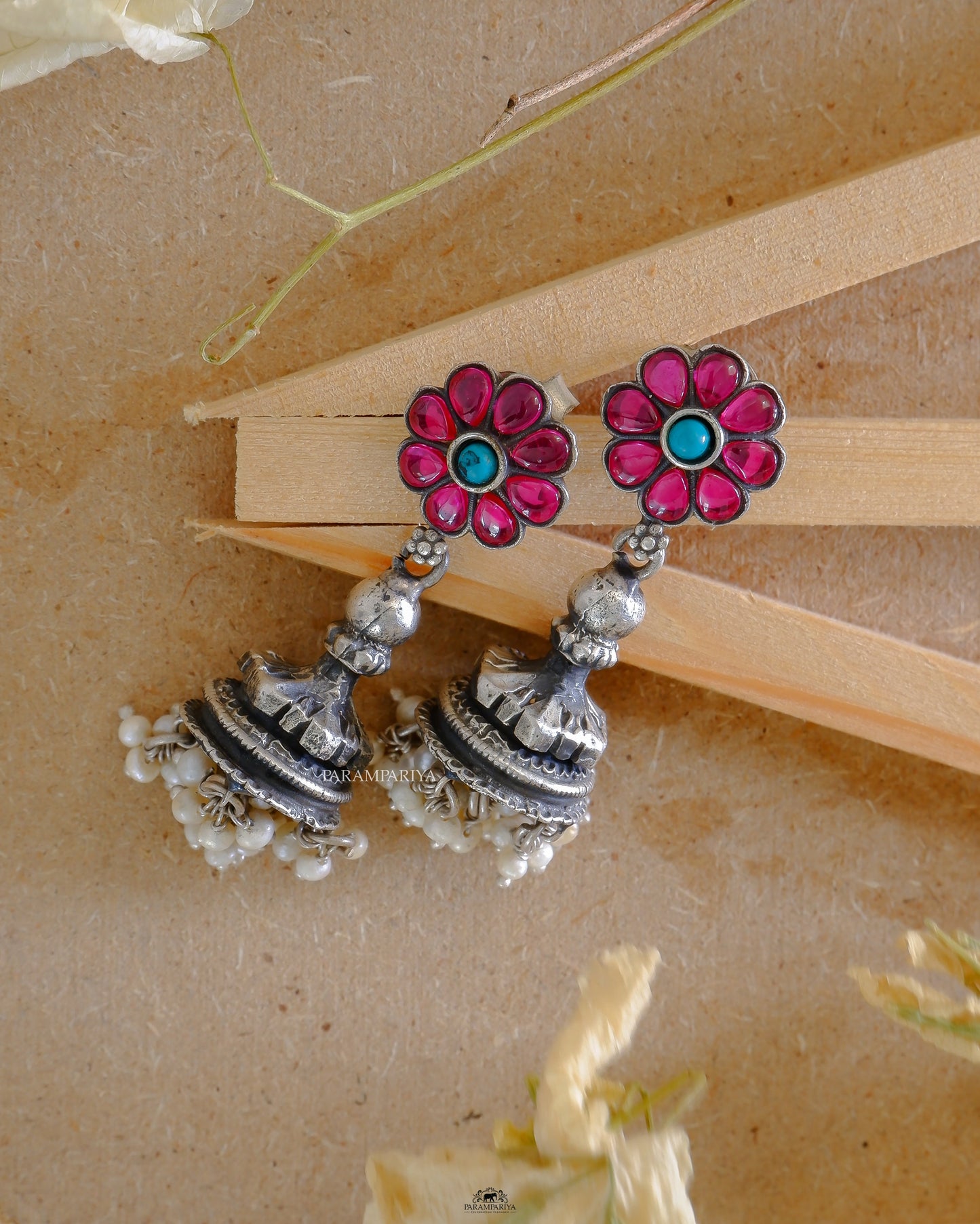 Our Orbit Earrings offer simple sophistication with a touch of elegance. Crafted from pure silver and lined with a delicate turquoise stone, these timeless jhumkas will add the perfect touch of sparkle to any look.