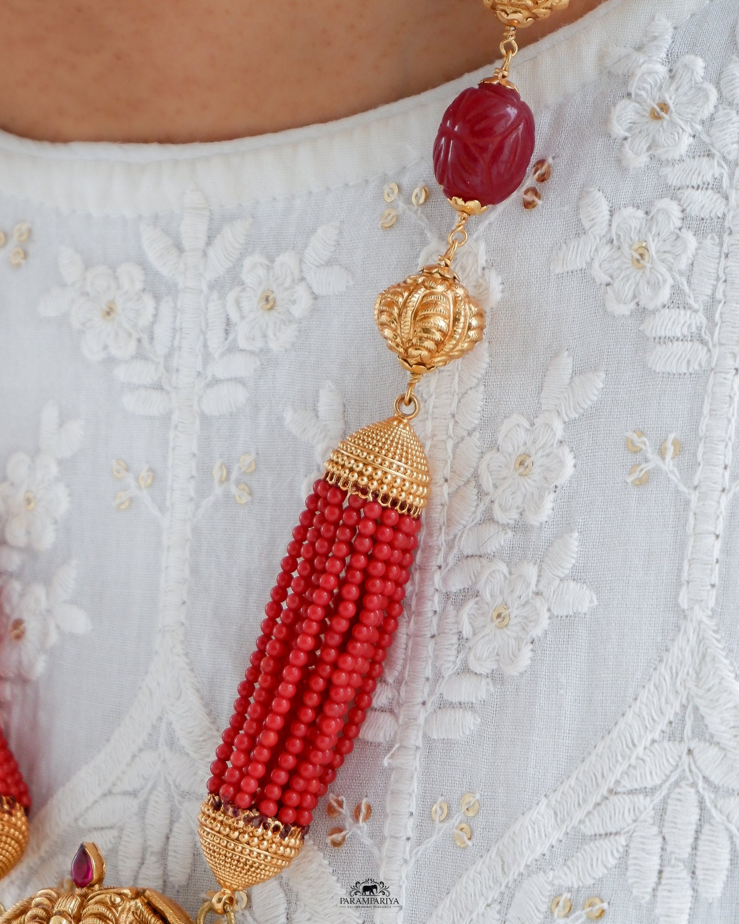 Uncover an artfully crafted unisex necklace adorned with an intricate charm of Lord Krishna and corals on www.parampariya.in. This exquisite jewel is made from pure silver and plated with antique gold microns for a beautiful finish.