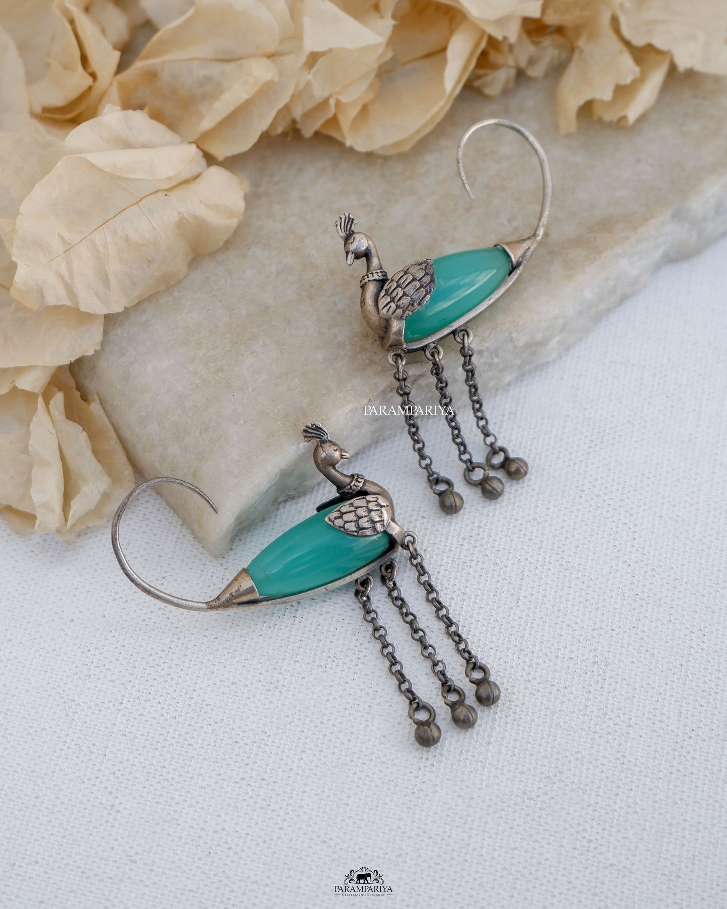 Exquisite stones embellish these stunning pure silver earrings,showcasing a delightful peacock motif.