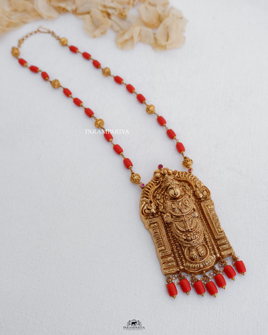 This exquisite temple necklace features a portrayal of Lord Balaji, intricately handcrafted with pure silver and accented with micron gold plating and semi-precious beads.