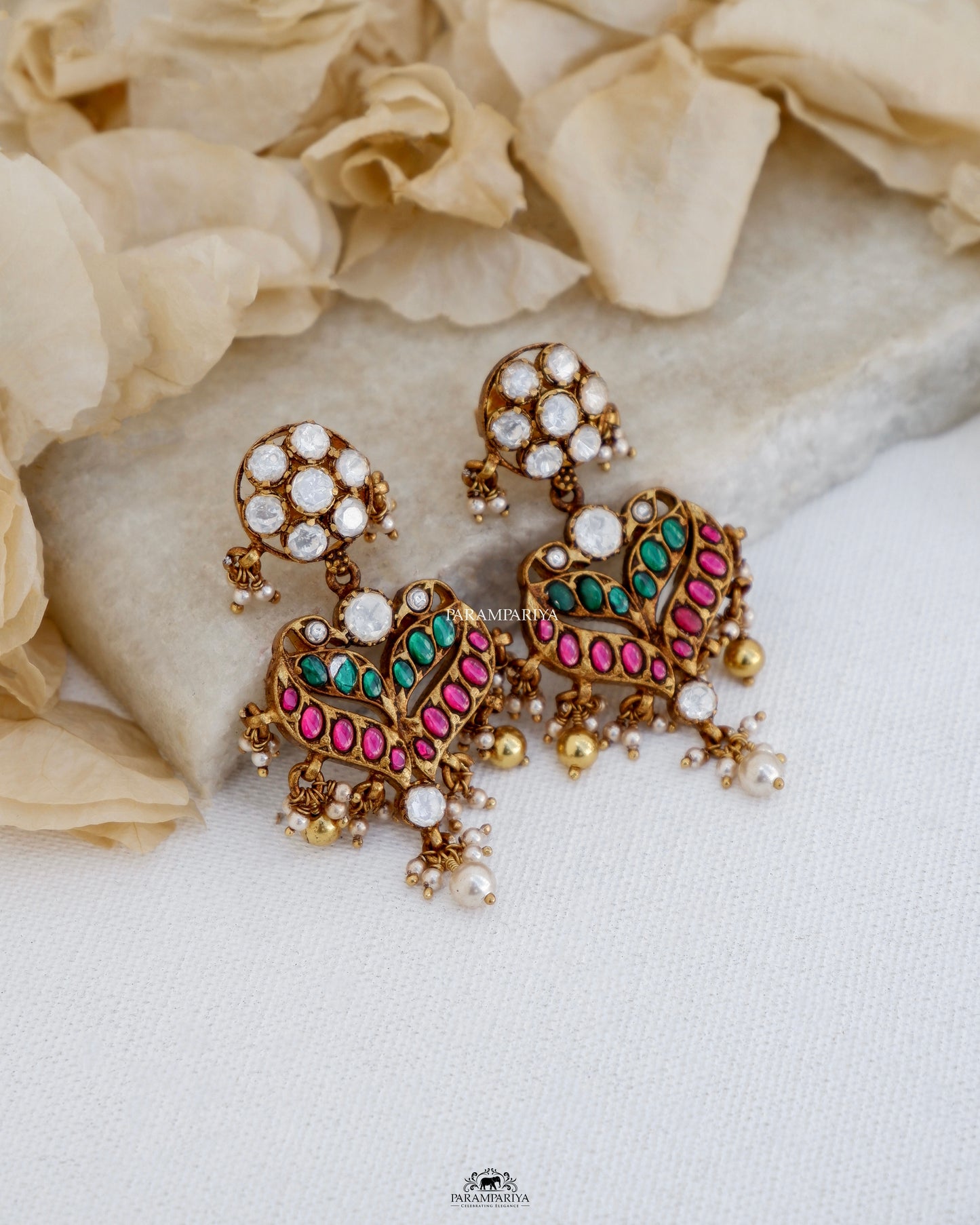 Experience the exquisite craftsmanship of our Gowri Earrings, featuring kundan detailing and moissanite stones set in pure silver with a micron gold plating. These earrings are a perfect addition to any ethnic ensemble.