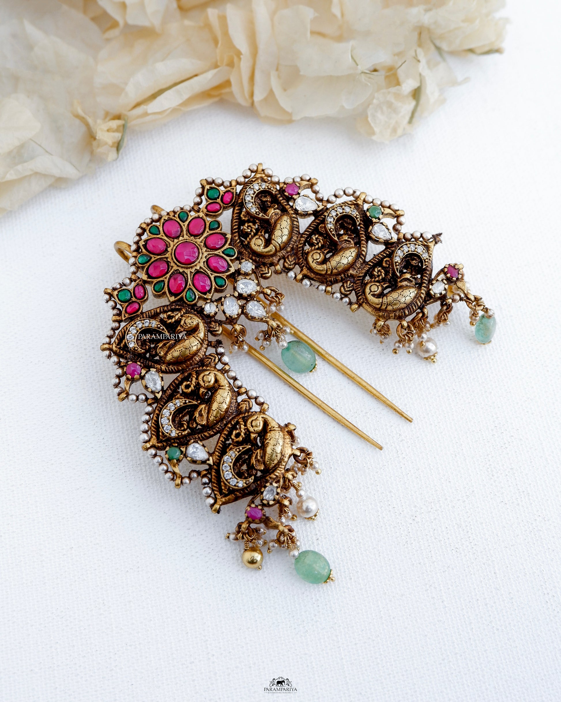 The Zara Billa is an exquisite Antique Bridal Jada billa, crafted with pure silver and gold micron plating. Adorned with kundan stones and sparkling moissanite stones, this piece exudes timeless beauty and elegance. Enhance your bridal look with this high-quality, expertly crafted billa. 