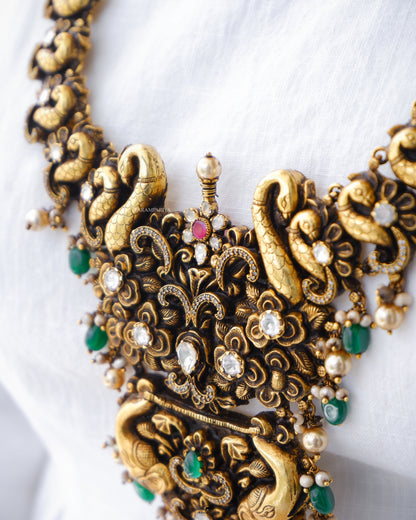Grandeur 92.5 pure silver gold micron plated nagas necklace adorning moissanite and zircon stones with pearls, a definite antique pick for your special occasions.