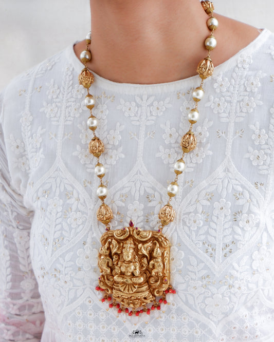 This exquisite silver necklace, adorned with intricate goddess Lakshmi detailing and gold micron plating, is a unique piece of temple jewellery.