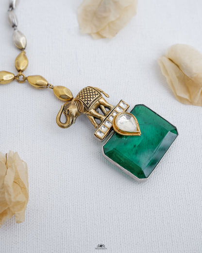 This stunning piece features a beautiful elephant design, adorned with a sparkling green doublet stone. Crafted with pure silver and dual tone plating, this necklace makes a statement of elegance and sophistication.