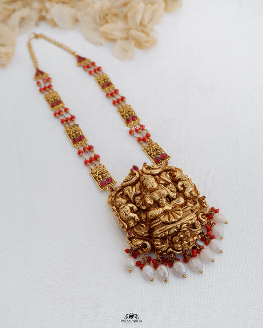 Divine temple necklace from the house of Parampariya depicting goddess Devi made up of pure silver with gold micron plating and semi precious coral beads.