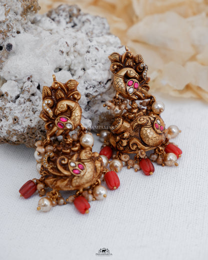 Pure silver micron gold plated nakshi earrings with kundan stones in antique finish for an ethnic look with coral beads.