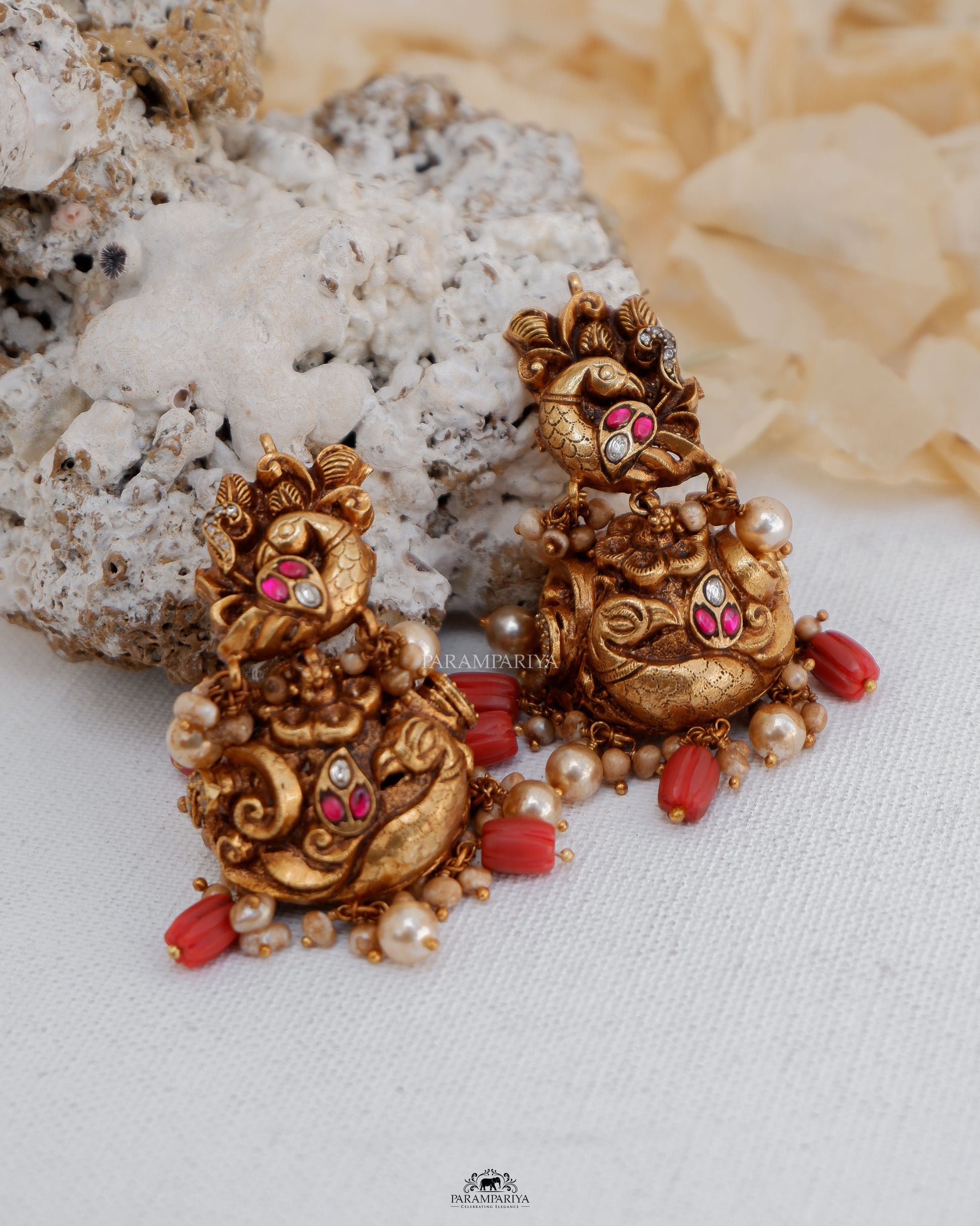 Pure silver micron gold plated nakshi earrings with kundan stones in antique finish for an ethnic look with coral beads.