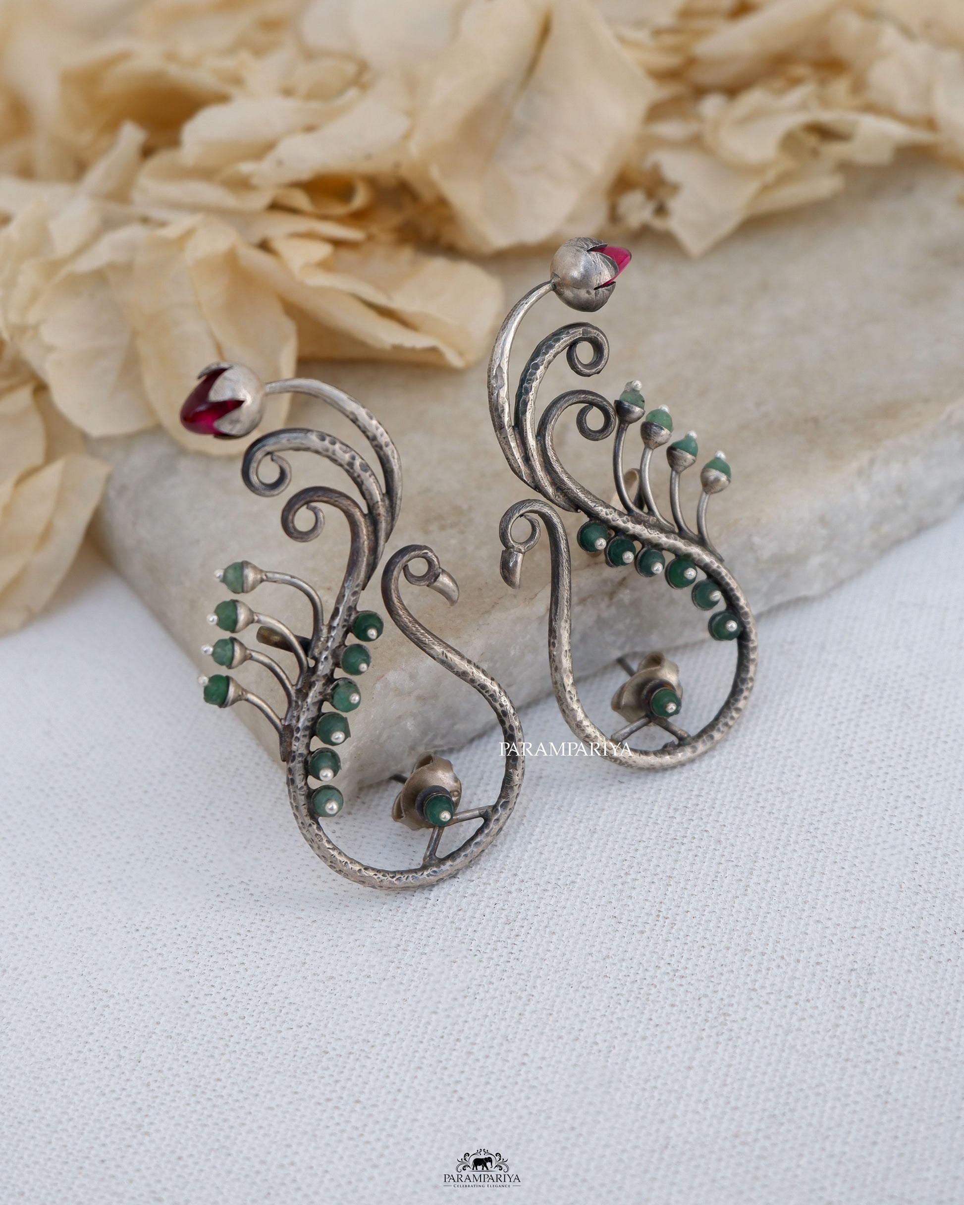 Exquisite stones embellish these stunning pure silver earrings,showcasing a delightful peacock motif.