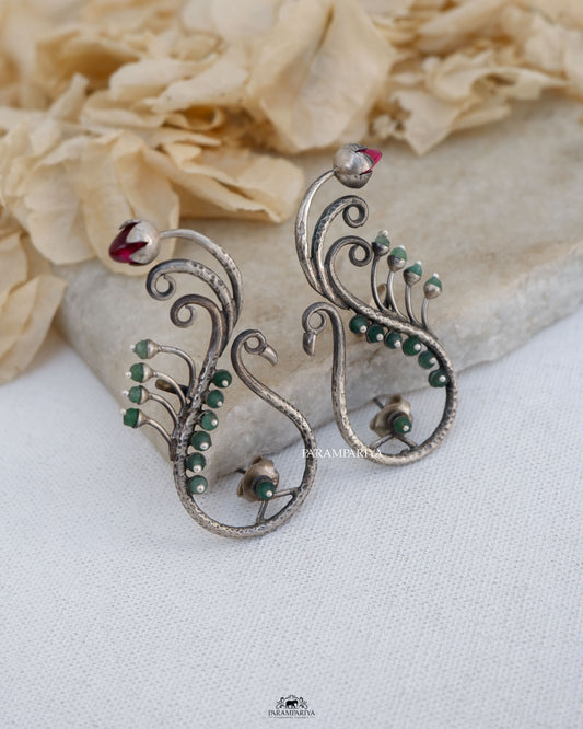 Exquisite stones embellish these stunning pure silver earrings,showcasing a delightful peacock motif.