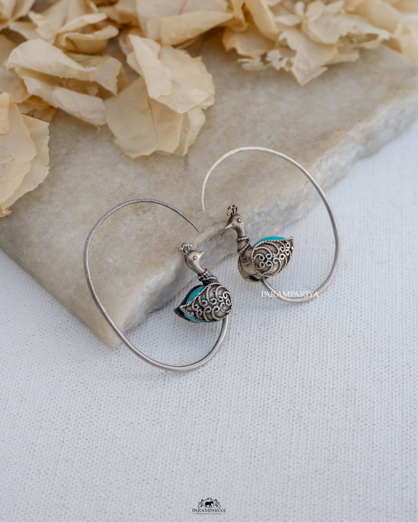 Exquisite stones embellish these stunning pure silver earrings,showcasing a delightful peacock motif.