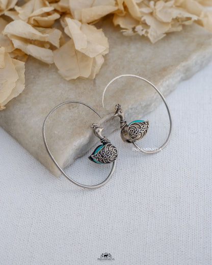 Exquisite stones embellish these stunning pure silver earrings,showcasing a delightful peacock motif.
