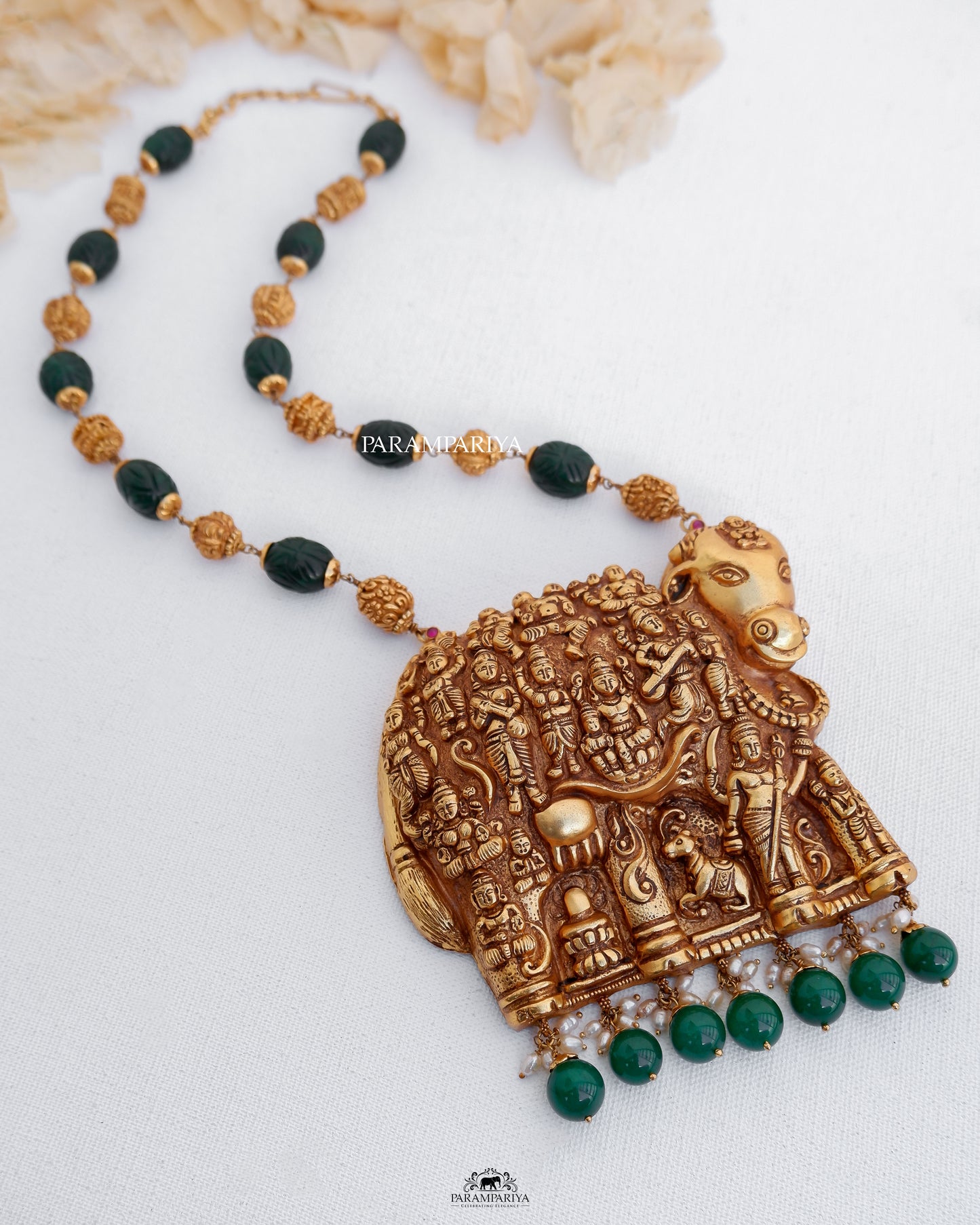 
Expertly handcrafted with pure silver and adorned with micron gold plating and semi-precious beads, this temple necklace showcases a stunning representation of Kamadhenu, creating a truly exquisite work of art.