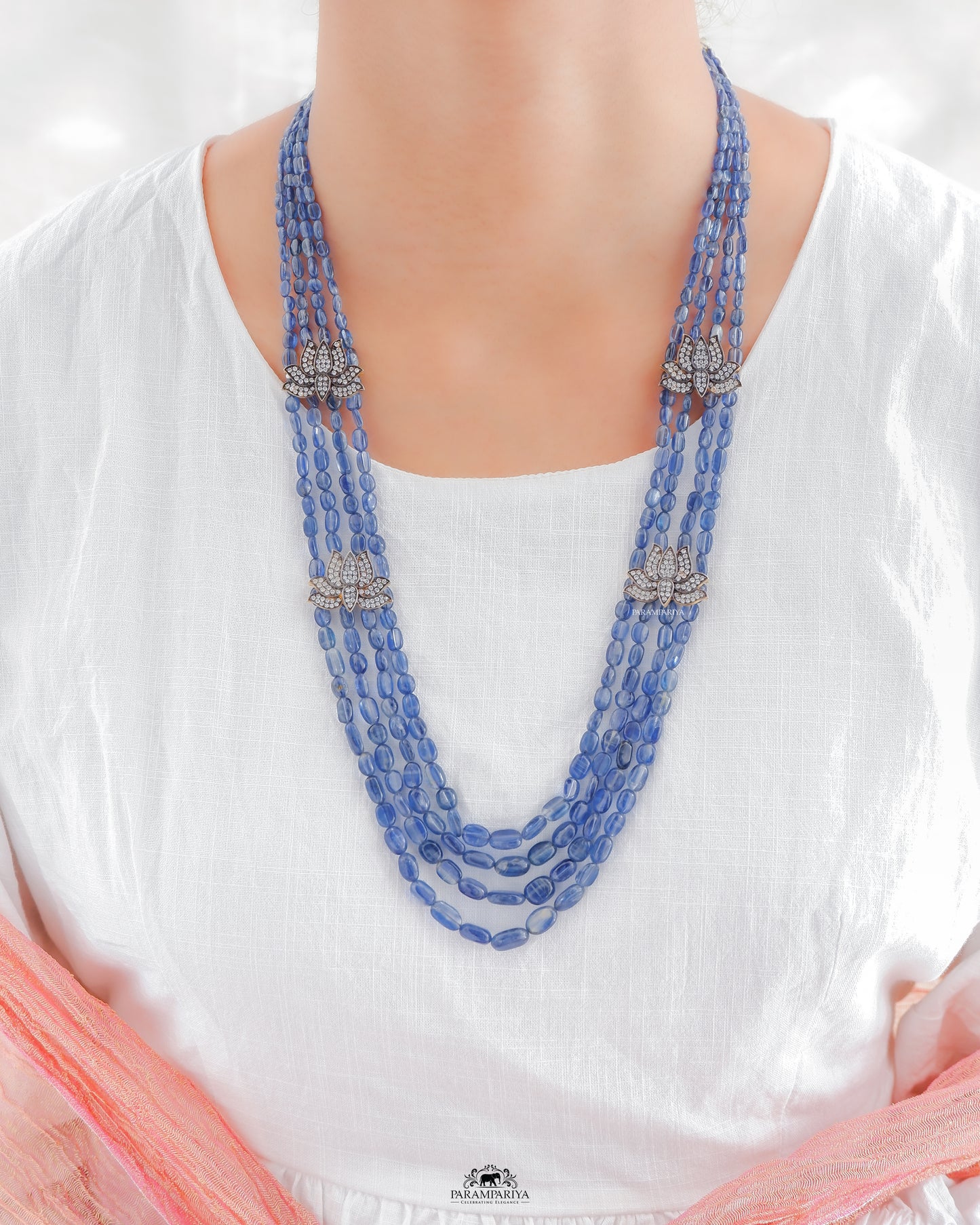 Kynite beads necklace adorned with silver zircon lotus motifs.
