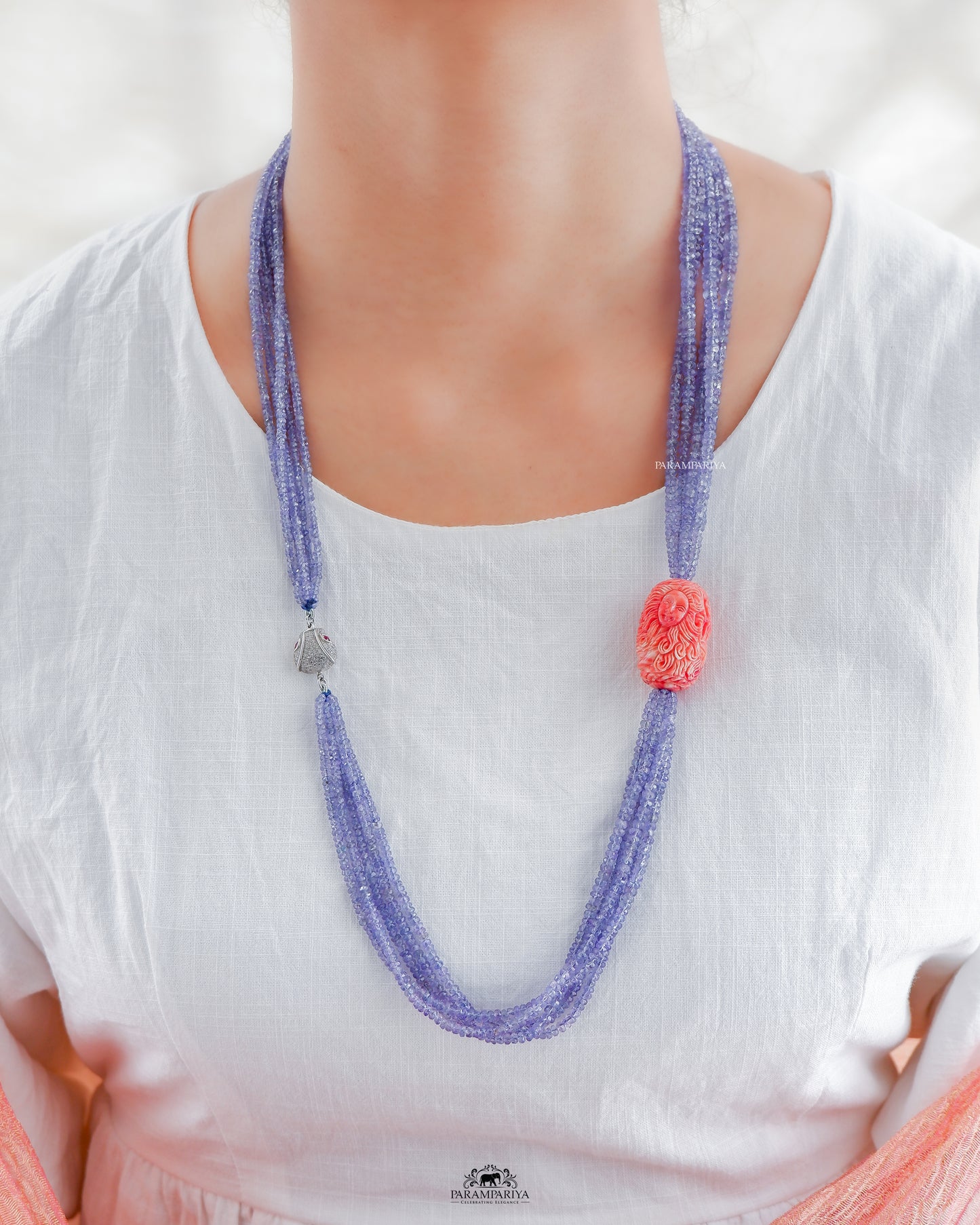 One of a kind tanzanite necklace with carved coral and zircon clip to enclose.