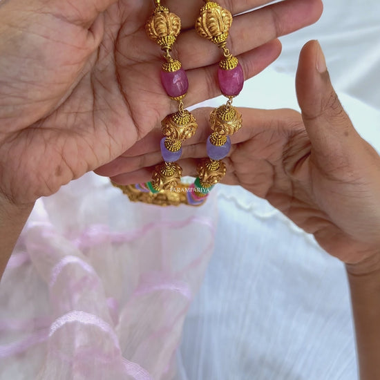 This Vish Necklace is expertly crafted from 92.5 pure silver with antique gold micron plating and adorned with semi-precious beads. It features intricately carved depictions of Lord Vishnu and Goddess Lakshmi, making it a bold statement piece.