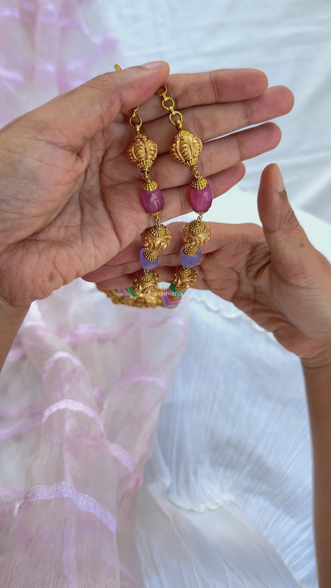 This Vish Necklace is expertly crafted from 92.5 pure silver with antique gold micron plating and adorned with semi-precious beads. It features intricately carved depictions of Lord Vishnu and Goddess Lakshmi, making it a bold statement piece.