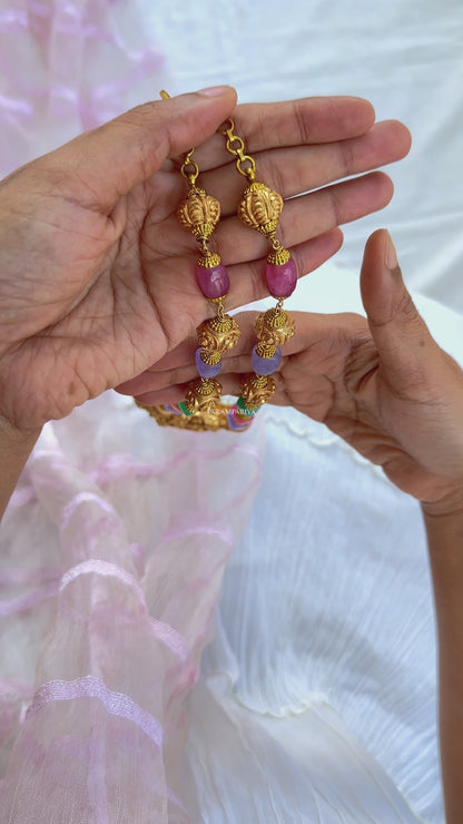 This Vish Necklace is expertly crafted from 92.5 pure silver with antique gold micron plating and adorned with semi-precious beads. It features intricately carved depictions of Lord Vishnu and Goddess Lakshmi, making it a bold statement piece.
